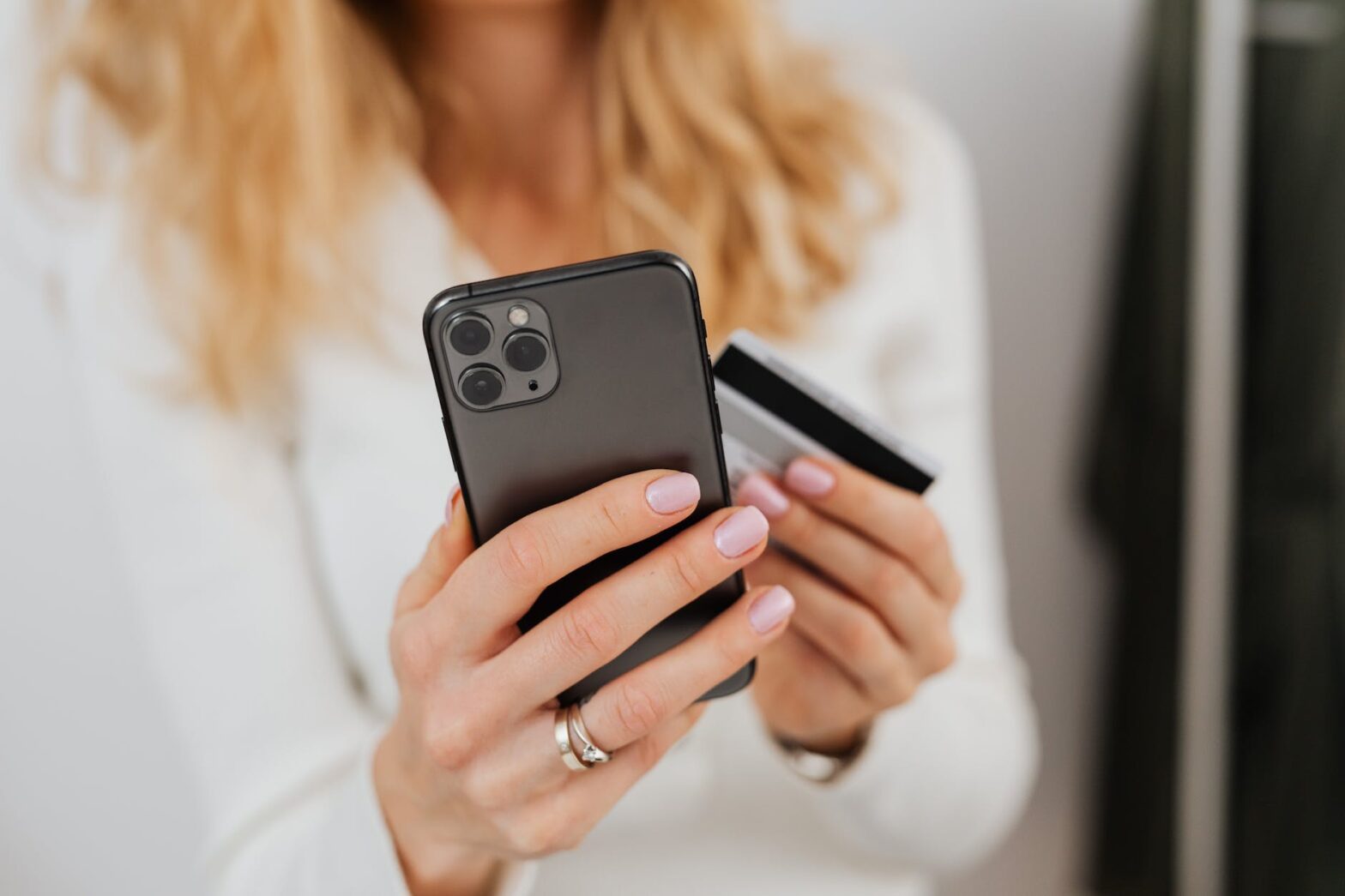 close up shot of a person holding a credit card and a smartphone